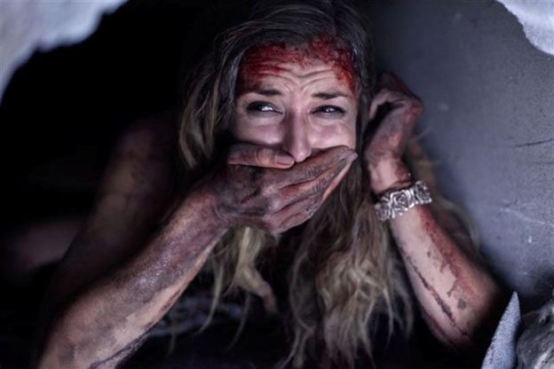 Lorenza Izzo as Kylie hiding from escaped cons in Aftershock