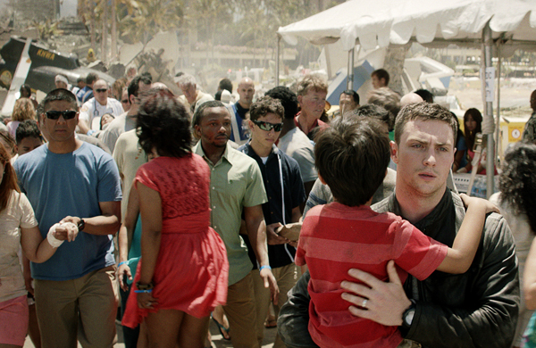 Ford Brody (Aaron Taylor-Johnson) saves a child during the attack on San Francisco