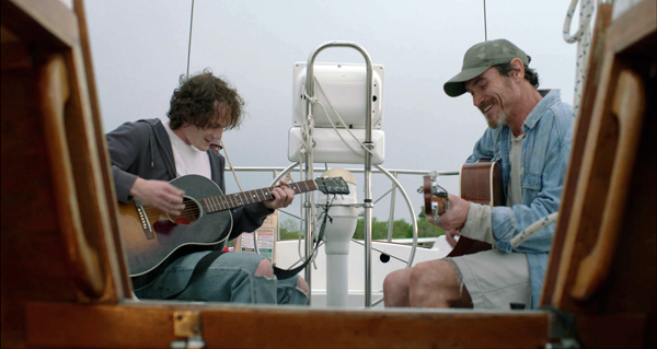 Quentin (Yelchin) and Sam (Crudup) jam on the boat