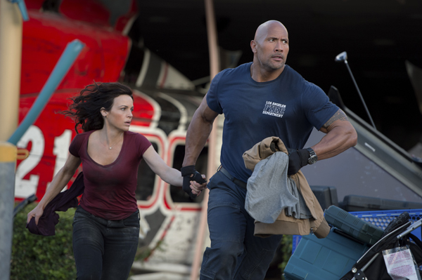 Carla Gugino as Emma and Dwayne Johnson as Ray are on the run from disaster in "San Andreas"