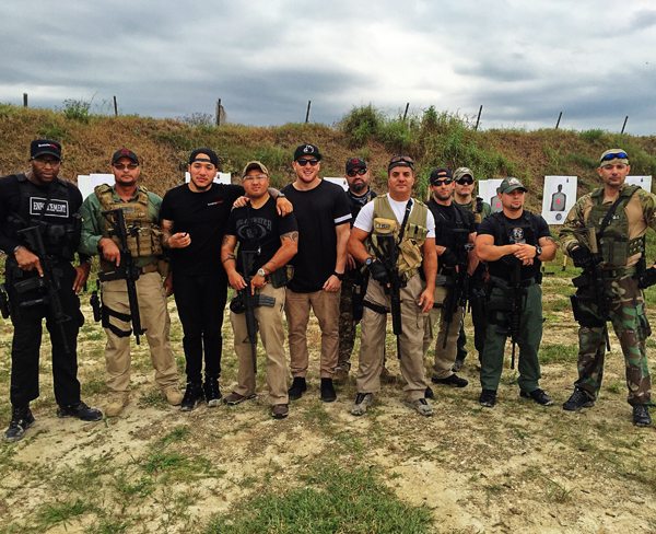 Director Jaren Hayman (center) poses for a picture at a secret Atlas Tactical Shadow Group training facility in Florida where they train agents for high-risk security detail around the globe