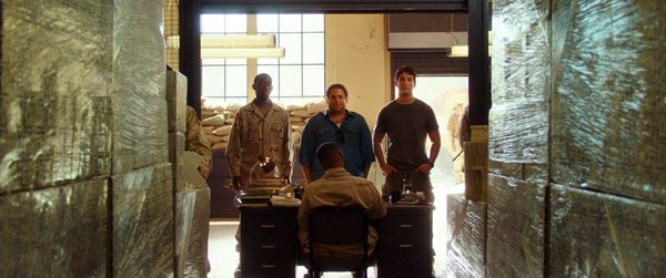 JONAH HILL as Efraim and MILES TELLER as David look at the millions of dollars in cash wrapped in clear wrap on pallets in WAR DOGS