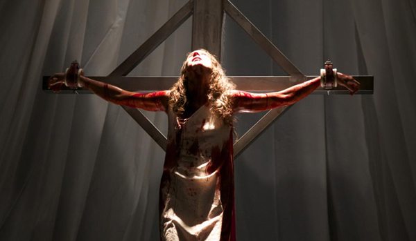Lucie (Troian Bellisario) gets hung on a cross in Martyrs