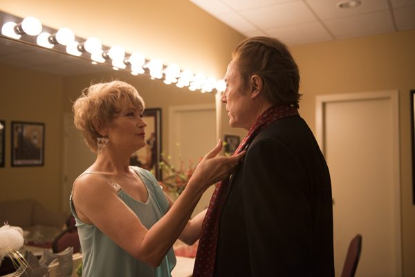 Lucille (Ann Magnuson)  helps Paul get ready to go on stage