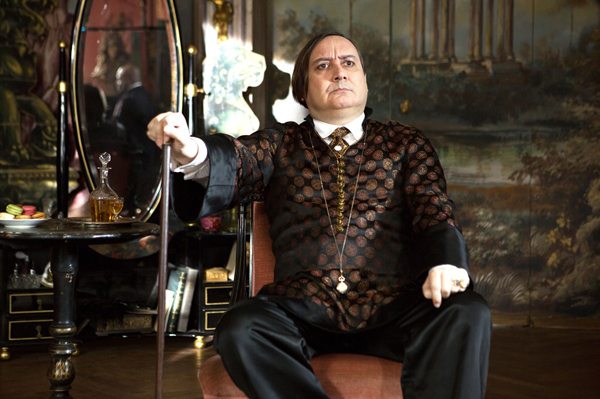 Michel Fau as Atos Pezzini, Marguerite's expensive voice coach