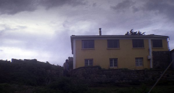 Sandokan (Roberto Farias) stands below the Priest's house of in THE CLUB